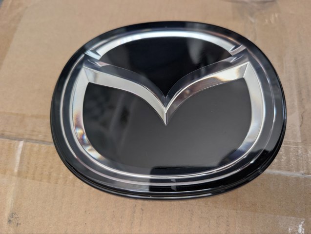 Фирменный значек решетки радиатора BERC51730 MAZDA