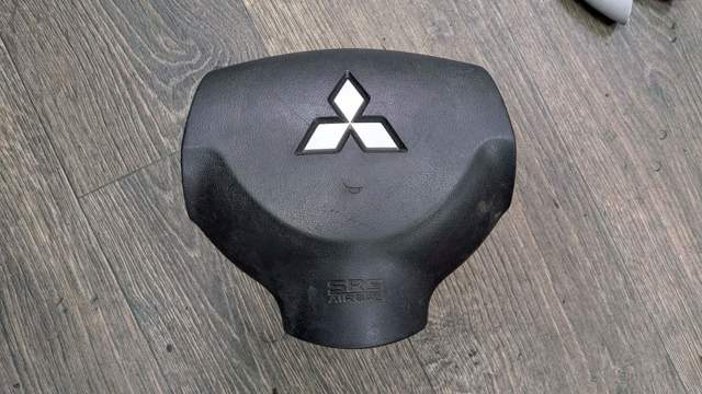 Подушка безопасности водителя 7030A263XA MITSUBISHI