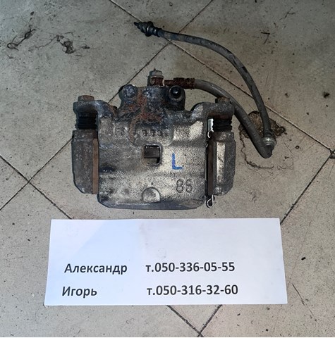 Суппорт тормозной, передний, левый 41011JN00A NISSAN