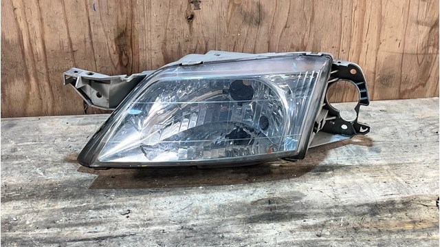 Вставка фары левой CB08510L0D MAZDA