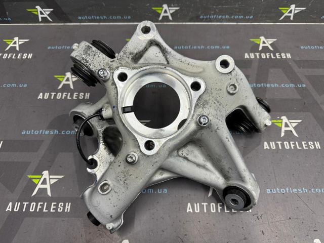 Кулак поворотный левый 104441100G Tesla Model