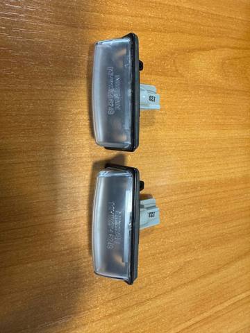 Фонарь подсветки заднего номера 265108991B NISSAN