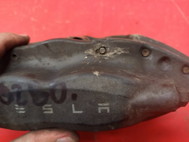 TESLA 102764300A Суппорт задний левый в наличии Каменское