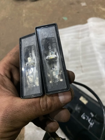 Фонарь подсветки заднего номера 265108990C NISSAN