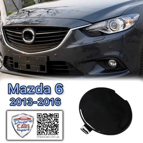 GHP950A11A27 Mazda Заглушка бампера буксировочного крюка передняя