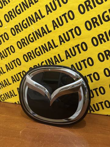 Эмблема решетки радиатора GSH751730 Mazda